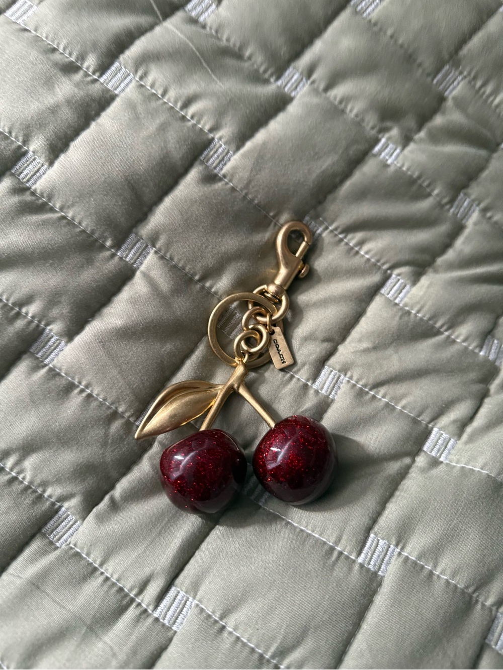 Coach Gold-Tone Cherry Charm Keychain with Deep Red Glitter Cherries